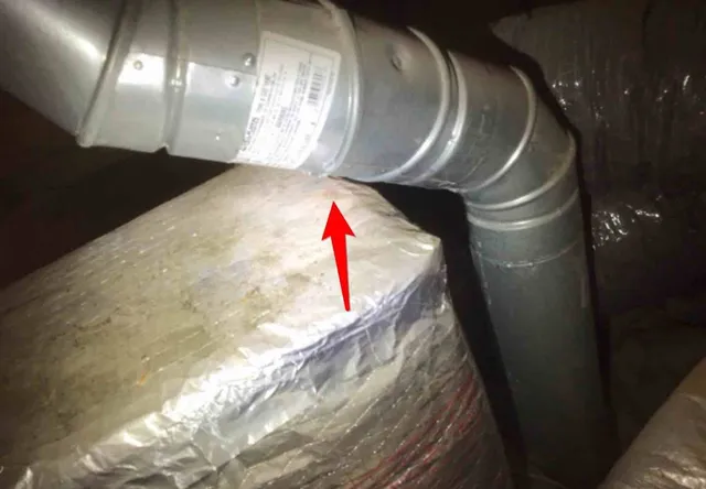 Furnace flue too close to wood in the attic: photo 1 from a Chicago inspection report