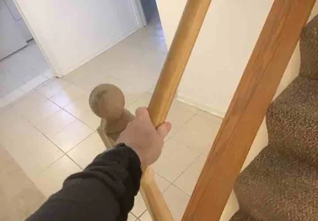Loose railing on the basement stairs: photo 1 from a Chicago inspection report