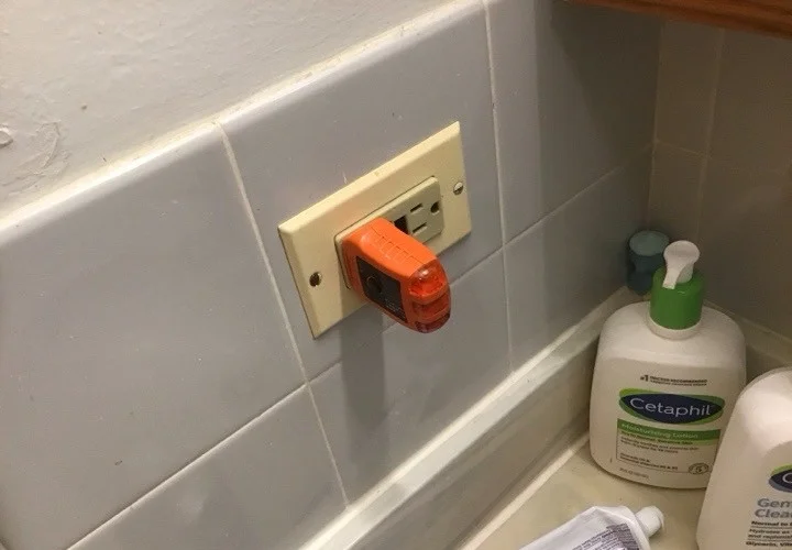 GFCI tester plugged into a bathroom outlet that did not trip