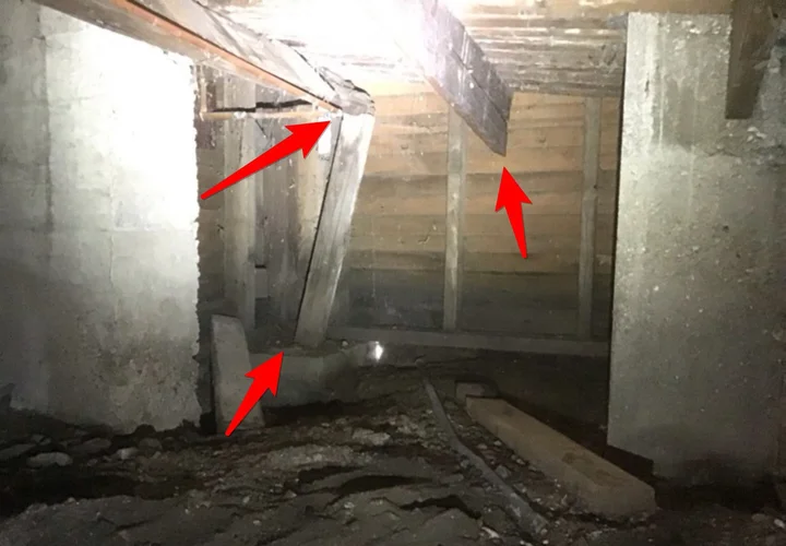 Rotted joists and a damaged support post in a crawlspace (photo 2)