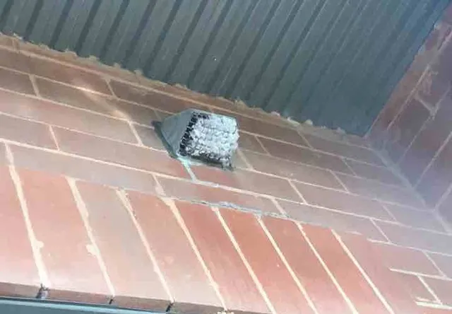 Dryer vent grate clogged with lint (fire risk): photo 1 from a Chicago inspection report