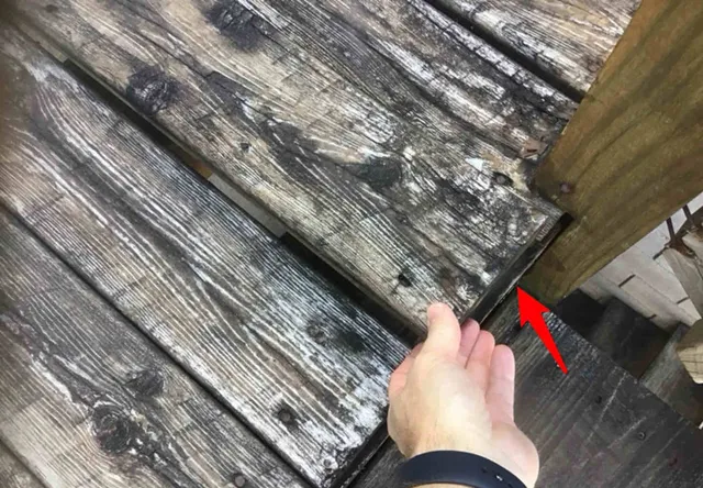 Rotting deck with loose boards and railings: photo 2 from a Chicago inspection report