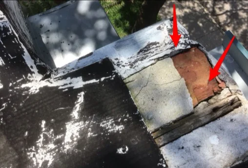 Cracked coping and spalling brick on a rooftop parapet wall (photo 2)