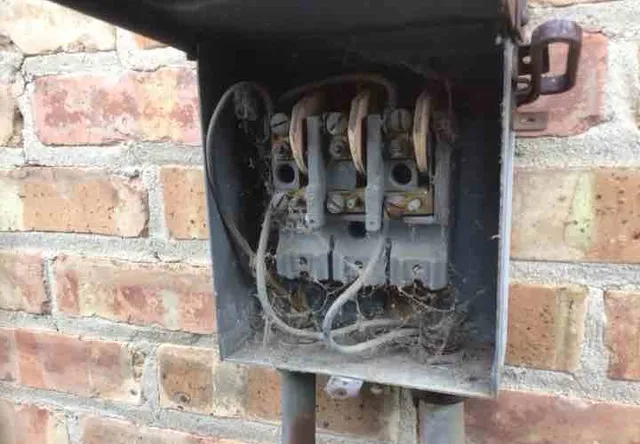 Exposed wiring at the AC disconnect: photo 1 from a Chicago inspection report