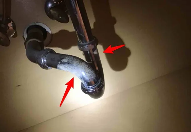 Corroded drain trap under the sink: photo 1 from a Chicago inspection report
