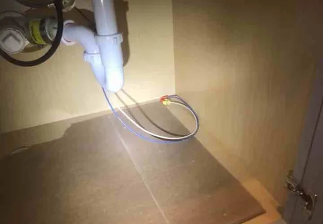 Exposed wiring under the sink: photo 1 from a Chicago inspection report