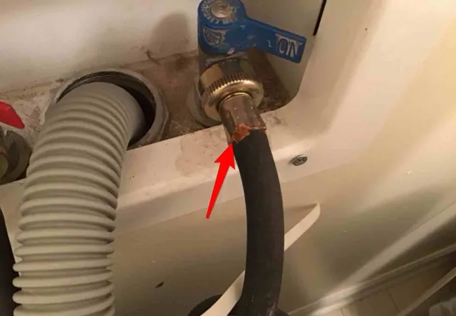Corroded washer supply hose: photo 1 from a Chicago inspection report