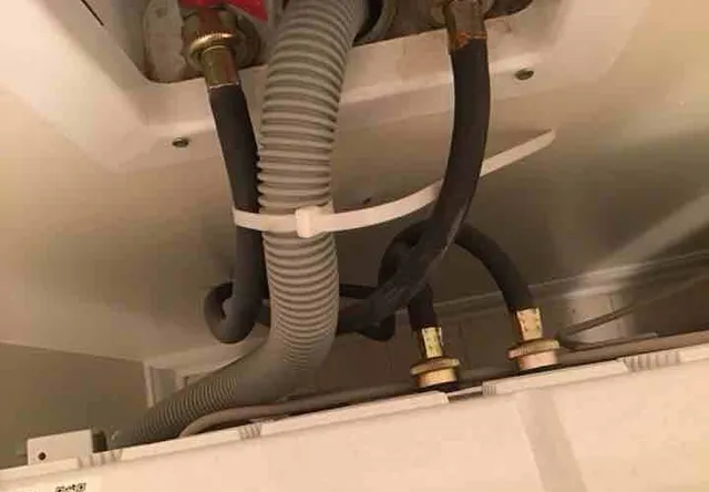 Corroded washer supply hose: photo 2 from a Chicago inspection report