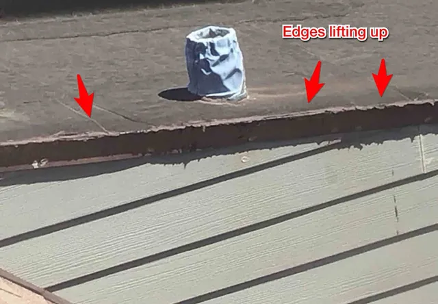 Flat roof edges lifting on the dormers: photo 2 from a Chicago inspection report