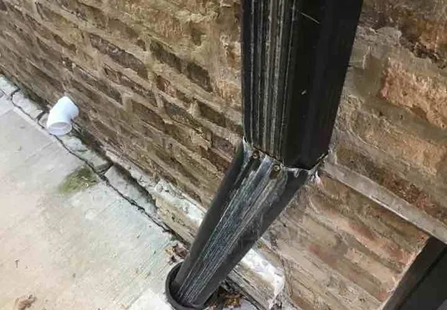Leaking downspouts: photo 2 from a Chicago inspection report