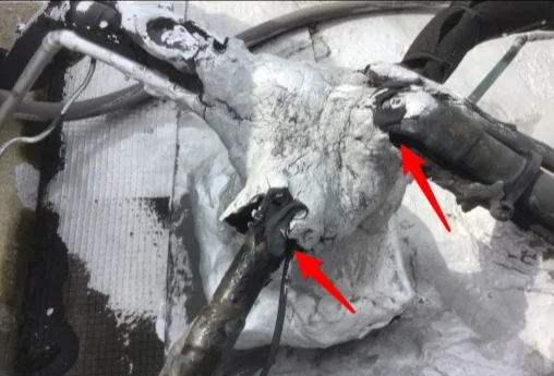 AC refrigerant line penetration sealed with excess sealant, next to an example of a proper boot