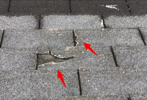 Worn, damaged asphalt shingles at the end of their useful life